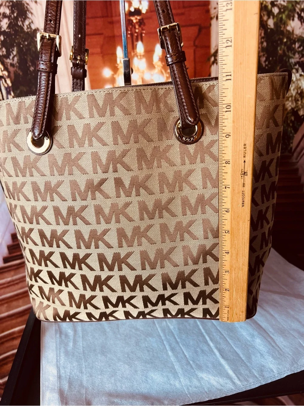 Michael Kors Jet Set tote features monogram canvas, contrasting leather straps